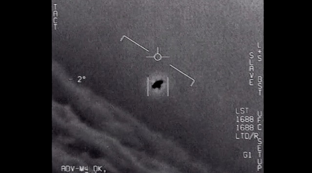 The image from video provided by the Department of Defense labelled Gimbal, from 2015, an unexplained object is seen at center as it is tracked as it soars high along the clouds, traveling against the wind. (AP Photo)