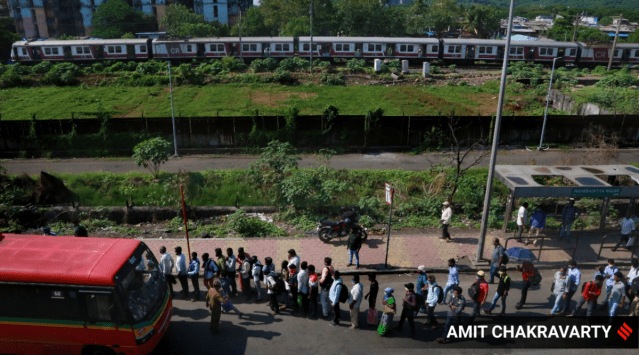 A long queue of commuters wait to board a bus in Mankhurd on Saturday. (Express Photo by Amit Chakravarty)