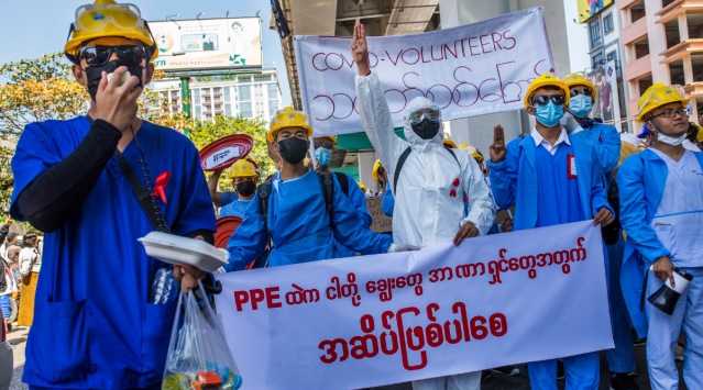 Health care workers wearing red ribbons, symbolizing opposition to the Myanmar’s military coup, protest the coup in Myanmar’s capital of Yangon.(The New York Times)
