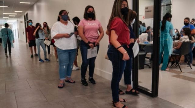 People wait to receive the Pfizer-BioNTech COVID-19 vaccine at the University of Texas Rio Grande Valley in Brownsville, Texas on June 8, 2021. (The New York Times)