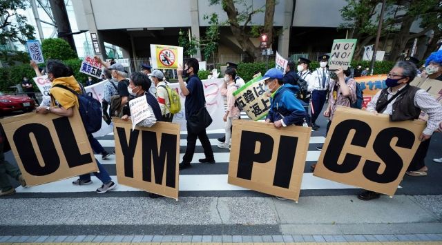Public sentiment in Japan has been generally opposed to holding the Tokyo Olympics and Paralympics. This is partly based of fears the coronavirus will spike as almost 100,000 people — athletes and others — enter for both events.(AP Photo/Eugene Hoshiko, File)