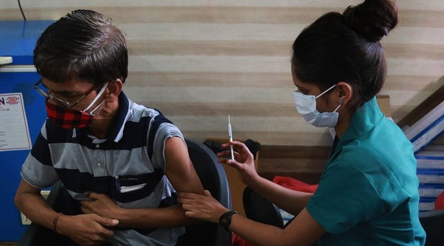 A health worker administers a dose of Covid-19 vaccine in Mumbai on Saturday. Representative image.(Express Photo: Amit Chakravarty)