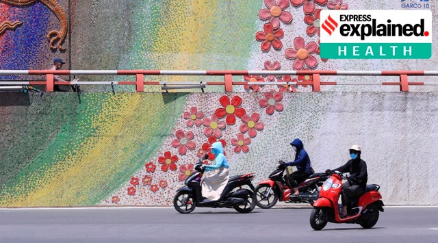 People wearing face masks ride motorcycles in Hanoi, Vietnam. The Communist nation has ramped up testing to contain the spread of the new Covid-19 variant. (Photo: AP)