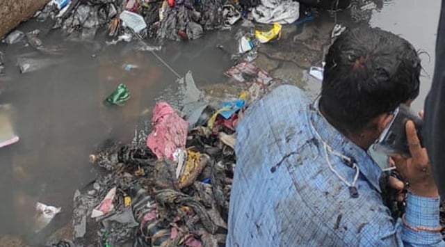 Shiv Sena MLA Dilip Lande and his supporters made a corporator in Mumbai sit on a waterlogged street and dumped garbage on him. (Express Photo)