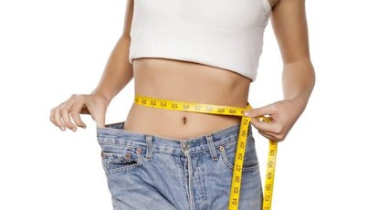 Premium Photo  Female body before and after weight loss diet concept woman  is measuring belly and legs in jeans