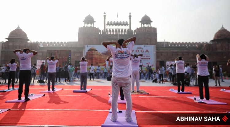 People perform Yoga on the occasion of International Yoga Day in front of the Red Fort in New Delhi on Monday. (Express Photo: Abhinav Saha)