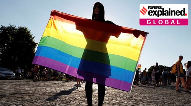 A demonstrator holds the LGBT flag during a protest against a law that bans LGBTQ content in schools and media at the Presidential Palace in Budapest, Hungary, June 16, 2021. (Reuters Photo)