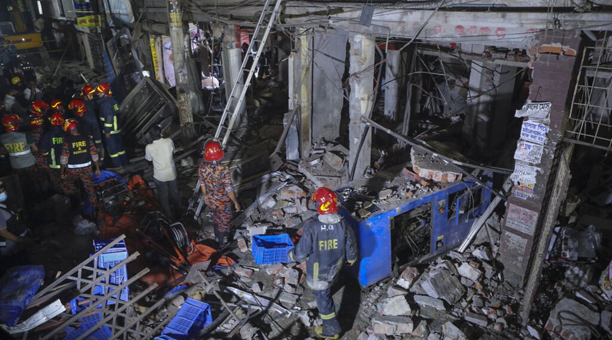 Rescuers stand amid the debris after a blast at a market in Dhaka, Bangladesh, Sunday, June 27, 2021. (AP Photo)