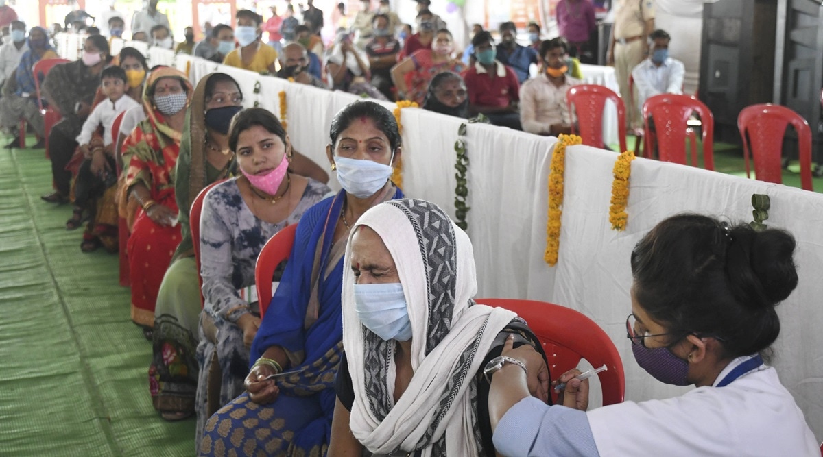 A health worker administers a Covid-19 vaccine during a vaccination drive in Bhopal, Monday, June 21, 2021. (PTI Photo)