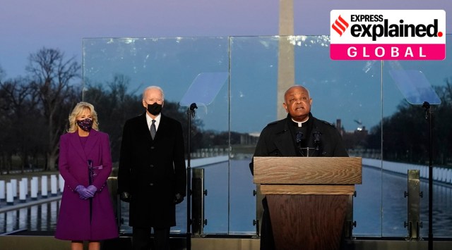 Joe Biden and his wife, Jill, listen as Cardinal Wilton Gregory, Archbishop of Washington, delivers the invocation during a Covid-19 memorial at the Lincoln Memorial Reflecting Pool in Washington. (AP Photo/Alex Brandon, File)