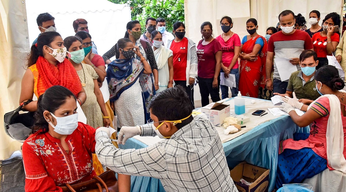A health worker administers a dose of the Covid-19 vaccine to a woman in Patna, Wednesday, June 9, 2021. (PTI Photo)