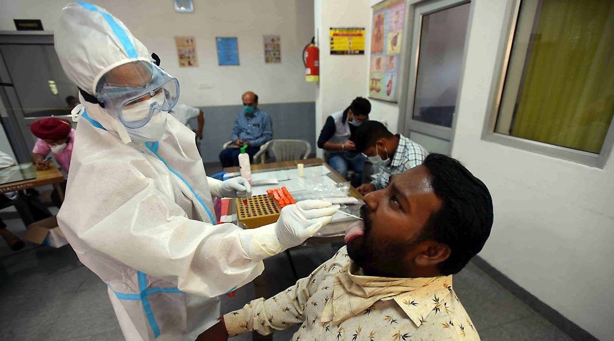 Health workers collecting swab samples for Covid-19 test at Punjab Engineering College in Sector 12 of Chandigarh. (Express Photo by Kamleshwar Singh)