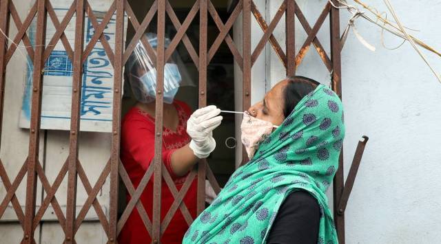 A health workers collect sample for COVID-19, Rapid antigentest at an Urban primary health centre in South Kolkata. (Express photo by Partha Paul)