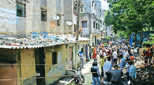 People gather at Saraswati Kagar Awaas in Surat after the death of a one-year-old girl. (Photo: Hanif Malek)
