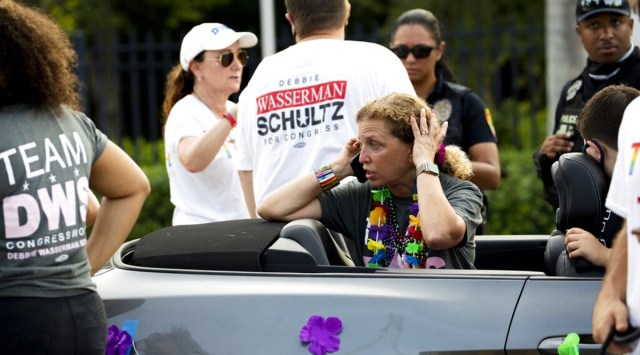 Rep. Debbie Wasserman Schultz, D-Fla., makes a call after a truck drove into a crowd of people during The Stonewall Pride Parade and Street Festival in Wilton Manors, Fla., Saturday, June 19, 2021. A driver has slammed into spectators at the start of a Pride parade in South Florida, injuring at least two people. (Chris Day/South Florida Sun-Sentinel via AP)