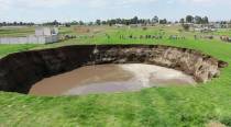 Massive sinkhole appears in Mexico field, threatens to swallow house