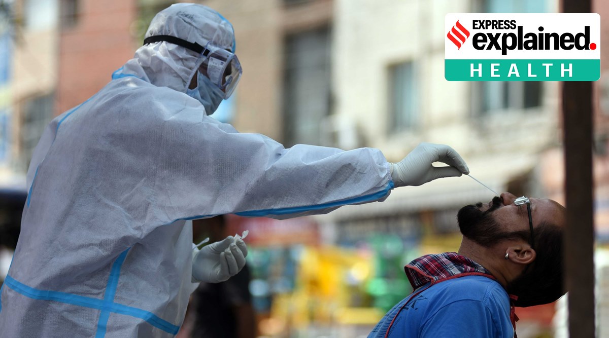 A health worker takes a sample for Covid-19 testing. (Express Photo: Kamleshwar Singh, File)