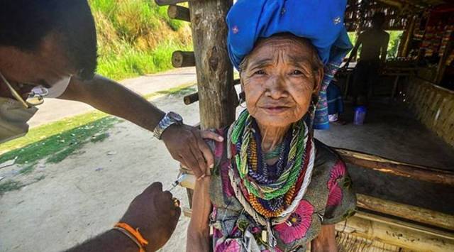 A Reang woman takes the COVID-19 vaccine at Gobindabari village in Chawmanu, near Agartala. (File Photo: PTI)