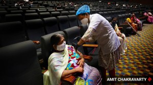 Beneficiaries being inoculated inside Vishnudas Bhave Auditorium, Vashi. (Express Photo by Amit Chakravarty)