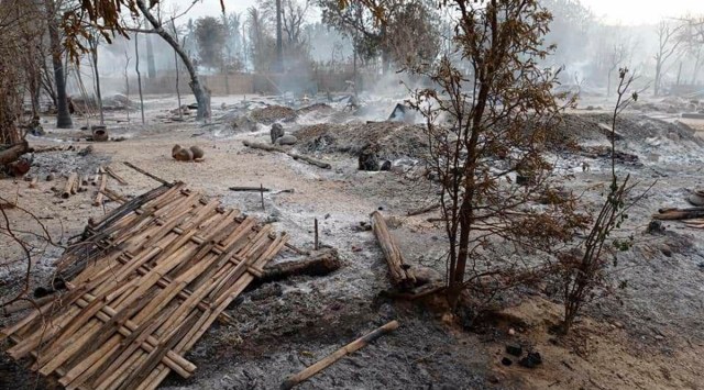 Smoke rises from smoldering houses in Kinma village, Pauk township, Magwe division, central Myanmar on Wednesday, June 16, 2021. Residents said people are missing after military troops burned the village the night before. (AP Photo)