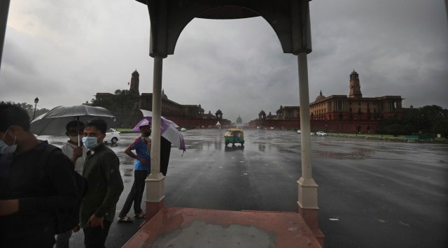 People take refuge under a traffic junction from rain at the Raisina hills in New Delhi (AP/File)