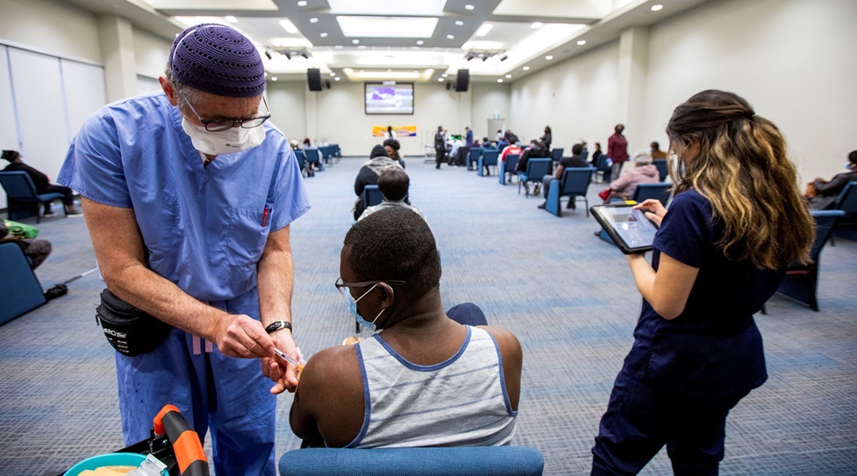 A healthcare worker administers a dose of a Covid-19 vaccine in Toronto. (Photo: Reuters)