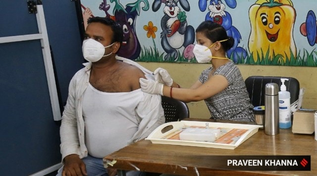 A man gets a shot of a Covid-19 vaccine in New Delhi. (Express Photo: Praveen Khanna)