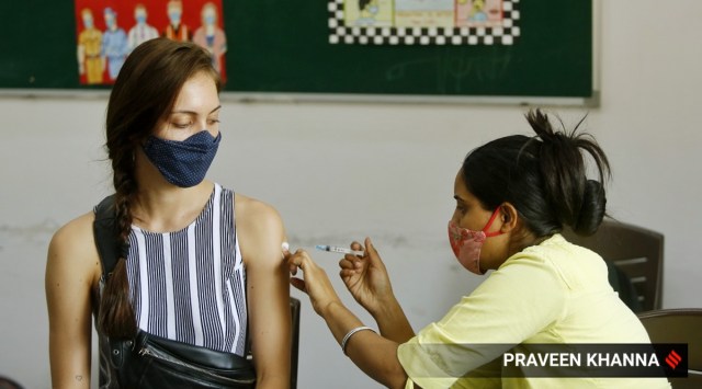 A beneficiary gets a shot of a Covid-19 vaccine in New Delhi. (Express Photo: Praveen Khanna)