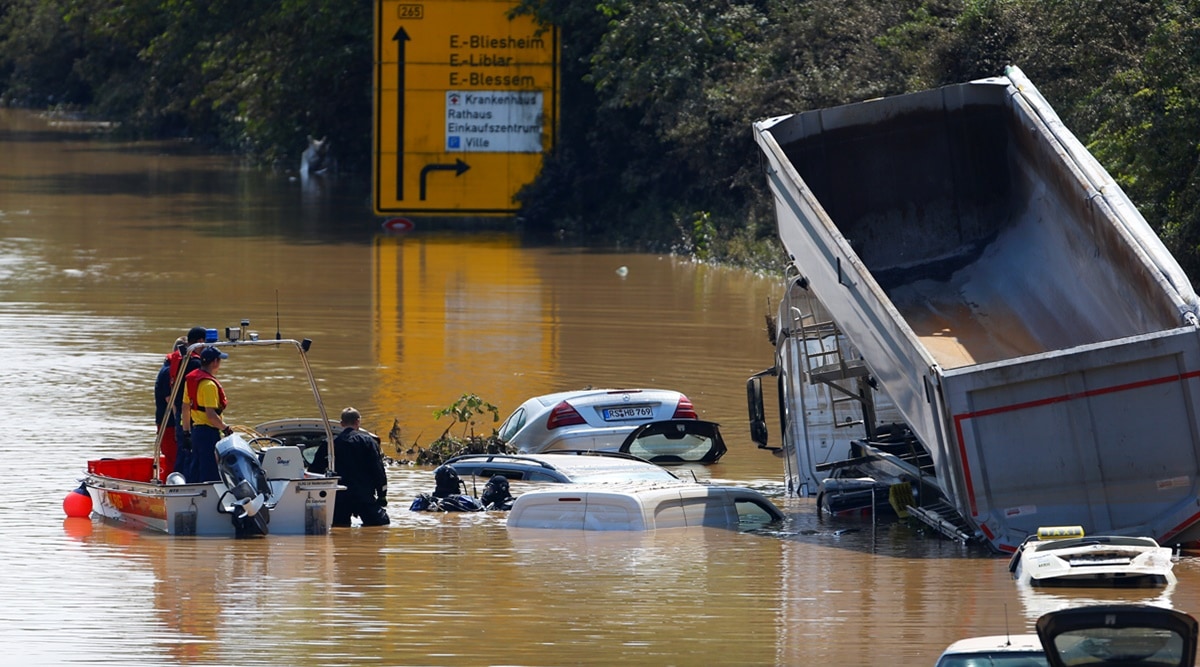 Divers from German Life Saving Association search at a flooded road following heavy rainfalls in Erftstadt-Blessem, Germany, on Saturday. (Photo: Reuters)