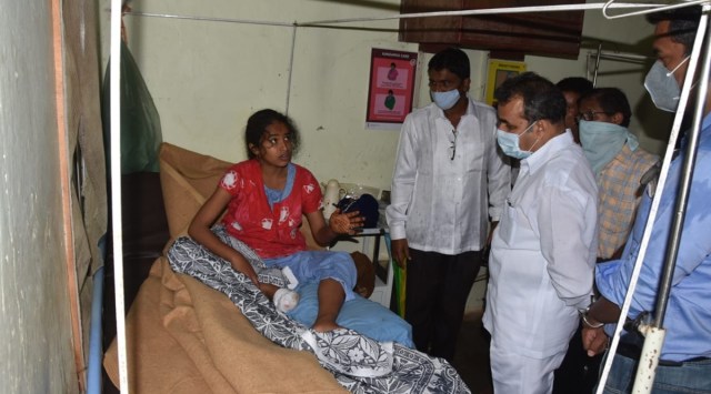 District Guardian Minister Balasaheb Patil visits the injured villagers from Mirgaon village at a local PHC 
