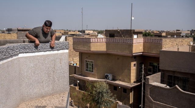 Ali Adil on the roof of his family home in Hilla, south of Baghdad, Iraq, on July 24, 2021. (Sergey Ponomarev/The New York Times)