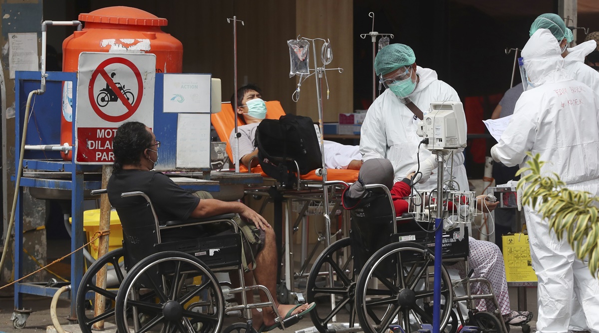 Paramedics tend to people at an emergency tent erected to accommodate a surge of COVID-19 patients at a hospital in Bekasi on the outskirts of Jakarta, Indonesia. (AP Photo)