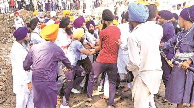 Construction volunteers and Sikh activists clash outside Golden Temple on Thursday morning. (Express Photo by Rana Simranjit Singh)