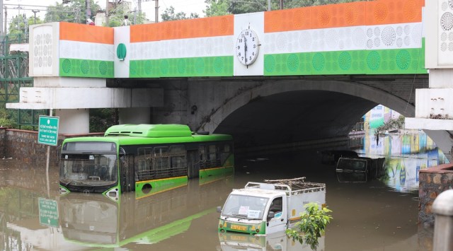A DTC bus and two Tempos one Auto submerged in water under the Minto Bridge in New Delhi after heavy rain. (Express Photo by Prem Nath Pandey/File)