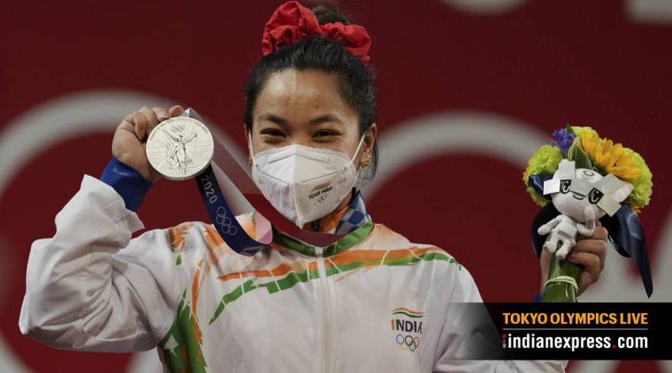 Tokyo Olympics 2020 Day 1 Highlights: India's Mirabai Chanu poses for photographs while standing on the podium after receiving the silver medal in women's 49 kg category weightlifting event (Source: PTI)