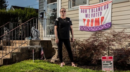 Andrea Dick outside her home, with one of the political signs a judge said she did not have to remove, in Roselle Park, N.J., July 19, 2021. (Bryan Anselm/The New York Times)