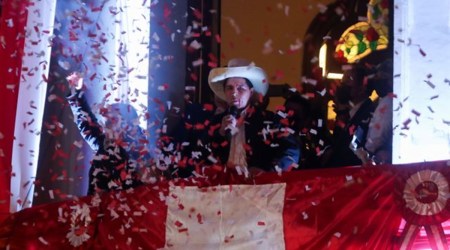 Leftist Pedro Castillo celebrates after Peru's electoral authority announced him as the winner of the presidential election, in Lima
