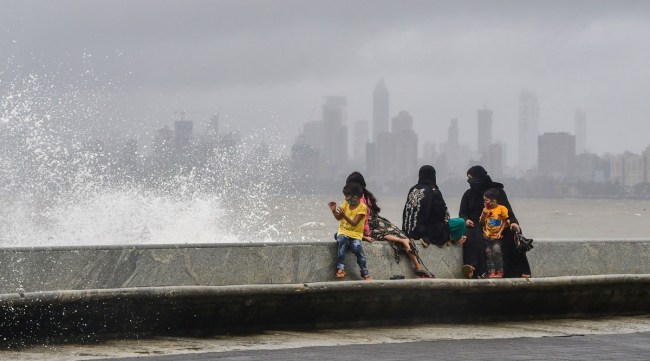 A family sits together at Marine Drive in Mumbai, Tuesday, July 13, 2021. (PTI Photo)