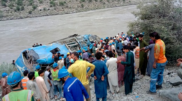 Local residents and rescue workers gather at the site of bus accident, in Kohistan Kohistan district of Pakistan's Khyber Pakhtunkhwa province, Wednesday, July 14, 2021. (AP)