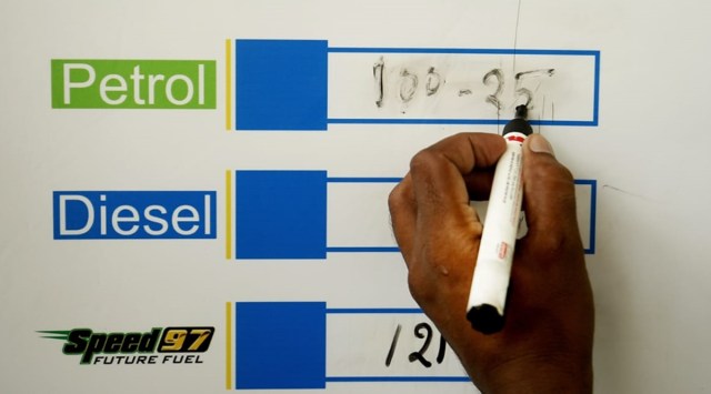 An employee at a petrol pump in New Delhi updates the fuel rates. (Express Photo: Praveen Khanna)