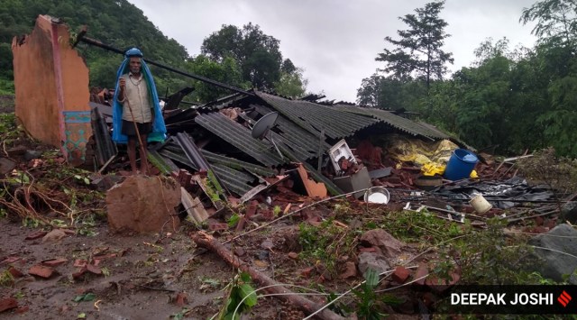 A resident of Taliye village stands near his house damaged by the landslide. (Express Photo: Deepak Joshi) 