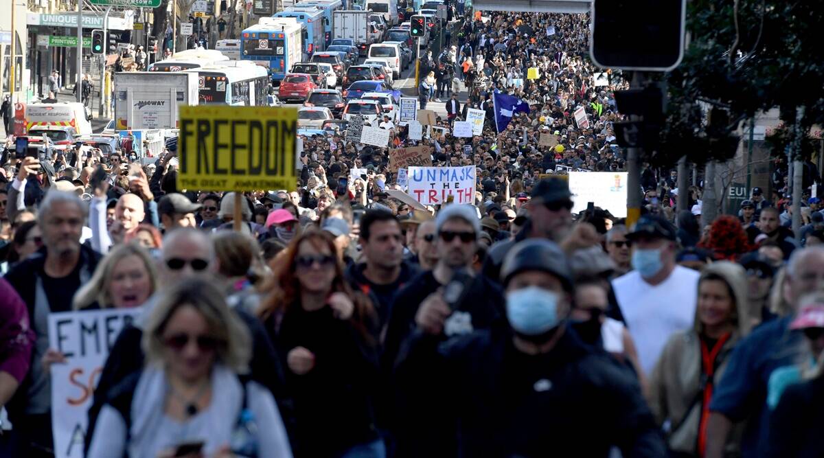 Protesters march through Sydney streets holding "Freedom" posters. (AP Photo)