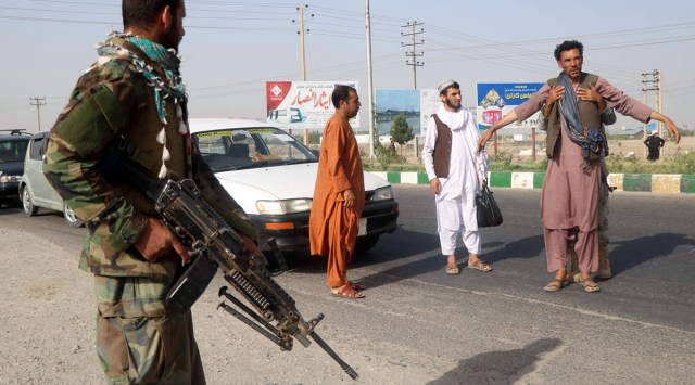 An Afghan National Army (ANA) soldier searches a man at a checkpoint in the Guzara district of Herat province, Afghanistan July 9, 2021. (Reuters)