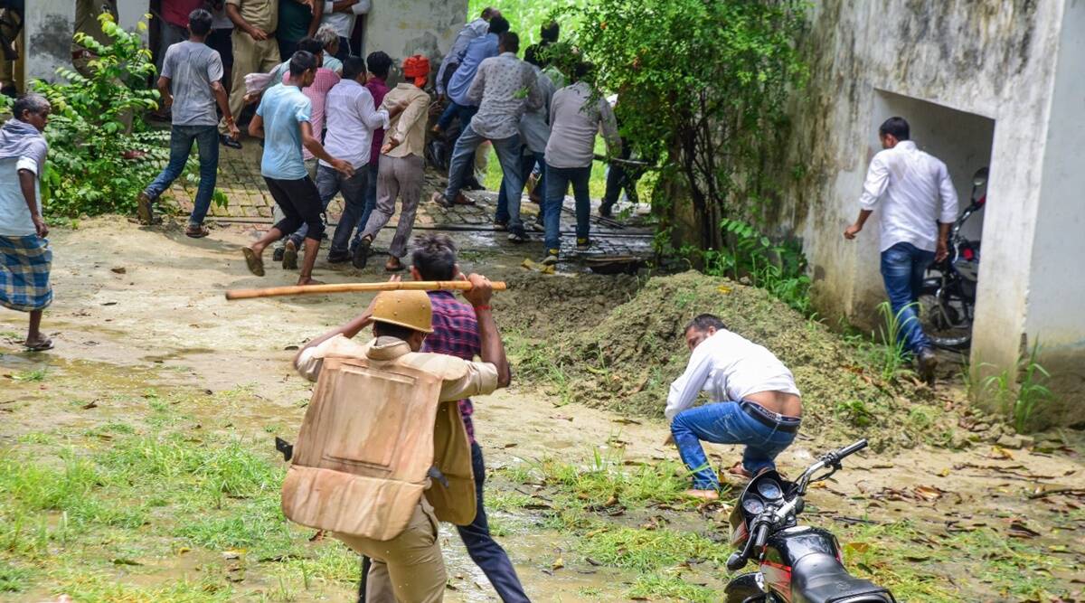 Police personnel baton charge on locals allegedly causing ruckus during the block head elections, in Ayodhya district, Saturday, July 10, 2021. (PTI)