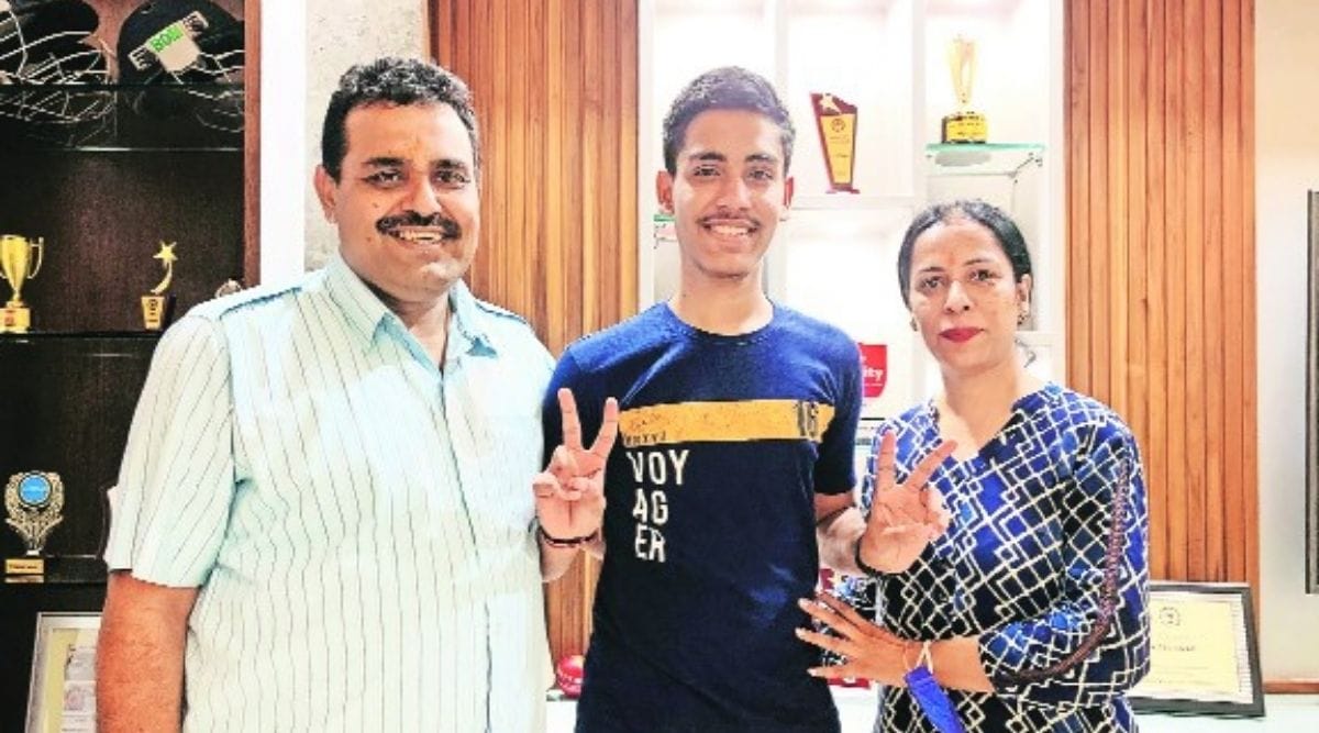 Hiteshwar Sharma with his parents on Friday.  (Express Photo)