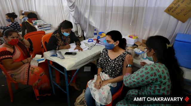 A woman gets a shot of a Covid-19 vaccine in Mumbai. (Express Photo: Amit Chakravarty)