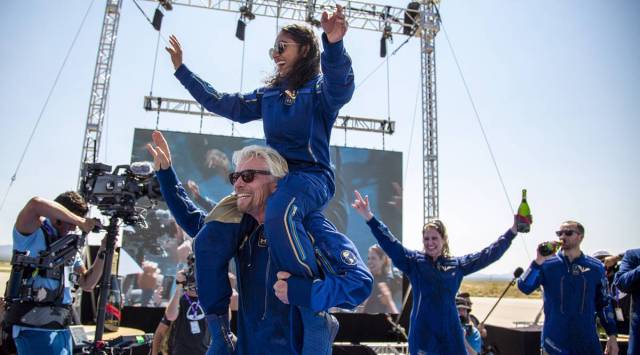 Virgin Galactic founder Richard Branson celebrates with Sirisha Bandla and other crew members at Spaceport America near Truth or Consequences, New Mexico, Sunday, after their 15-minute space flight aboard VSS Unity. (AP)