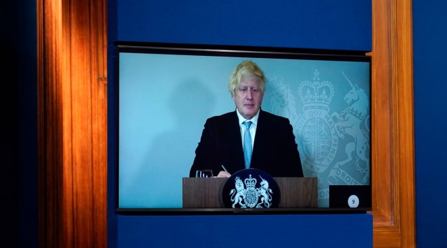 Britain's Prime Minister Boris Johnson appears on a screen from Chequers, the country house of the Prime Minister where he is self-isolating, during a media briefing in Downing Street, London. (AP)