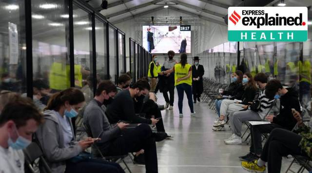 People sit in a waiting room after receiving their COVID-19 vaccine at the Vaccine Village in Antwerp, Belgium. (AP Photo)