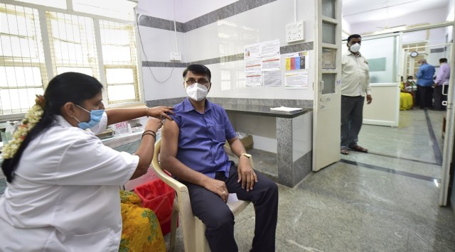 A medic administers the second dose of Covid-19 vaccine to a beneficiary at a hospital in Bengaluru. (Photo: PTI)